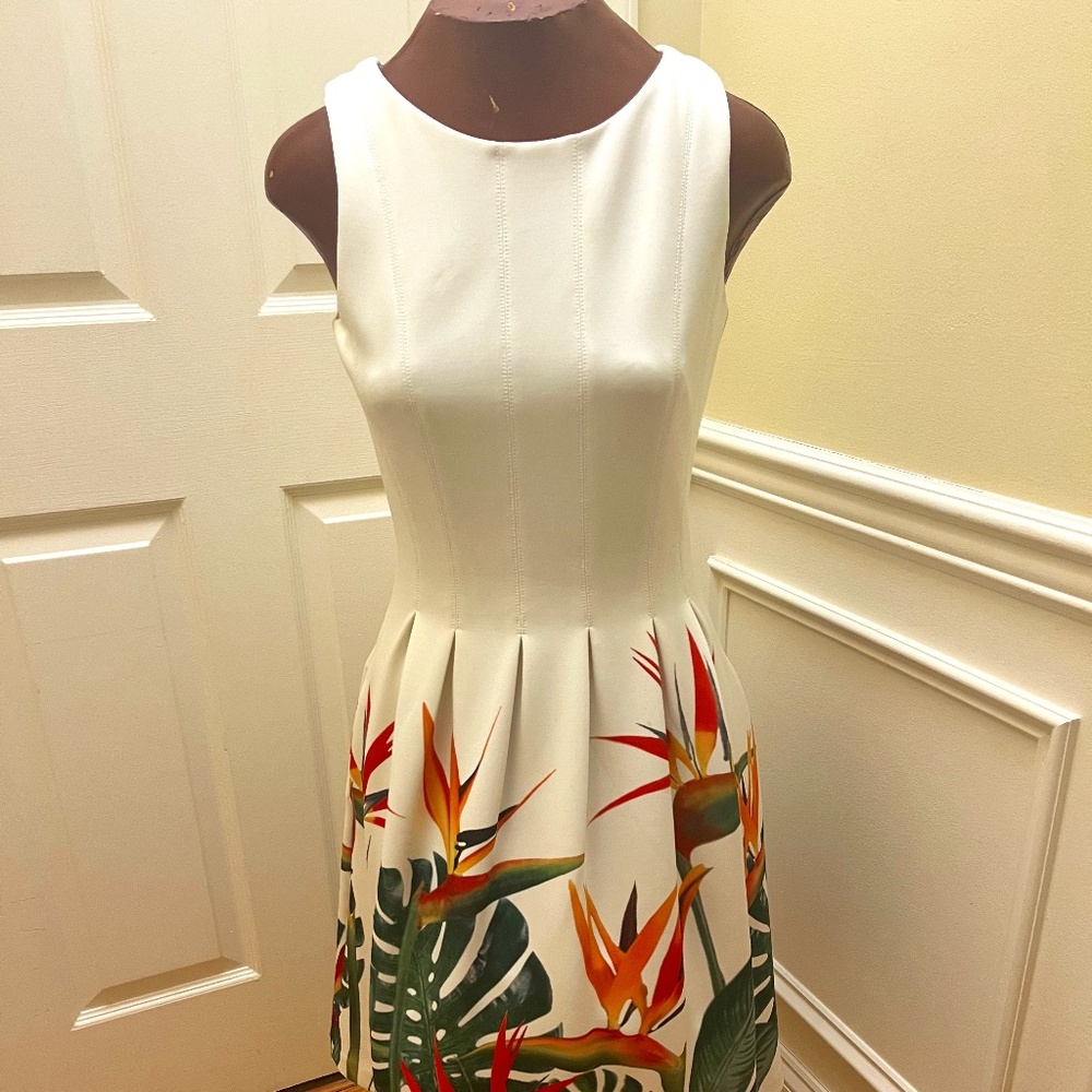 White dress with birds of paradise print across bottom